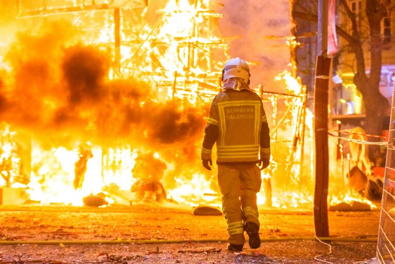 Firefighter with his protective suit working controlling the burning of a Falla