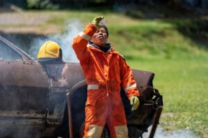 Fireman wearing fire protection suite and oxygen tank rest relax drink water after exercise